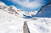 Aerial view of cars driving on mountain road in winter, Julier Pass, Albula district, Engadine, canton of Graubunden, Switzerland, Europe