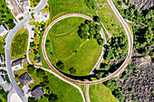 Aerial of the Brusio spiral viaduct, UNESCO World Heritage Site, Rhaetian Railway, Switzerland, Europe