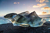 Iceberg from melting glacier on black sand beach near Jokulsarlon glacier lagoon, Vatnajokull National Park, Iceland, Polar Regions