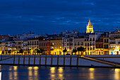Waterfront view of Seville at night, Andalucia, Spain, Europe