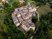 Aerial drone view of the village of Torre del Colle at sunset, Umbria, Italy, Europe