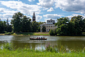 Gondola ride on the canal, Bible Tower, Wörlitz Castle, Garden Kingdom of Dessau-Wörlitz, Wörlitz Park, Unesco World Heritage Site, Wörlitz, Saxony-Anhalt, Germany