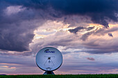 A radio telescope of the Raisting earth station in front of picturesque thunderclouds, Raisting, Upper Bavaria, Bavaria, Germany