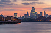 View of The City skyline at sunset from the Thames Path, London, England, United Kingdom, Europe