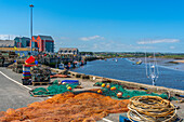 View of fishing nets on quayside and River Coquet at Amble, Morpeth, Northumberland, England, United Kingdom, Europe