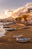 View of boats on beach in Baha de Arrecife Marina surrounded by shops, bars and restaurants at sunset, Arrecife, Lanzarote, Canary Islands, Spain, Atlantic, Europe
