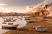 View of boats on beach in Baha de Arrecife Marina surrounded by shops, bars and restaurants at sunset, Arrecife, Lanzarote, Canary Islands, Spain, Atlantic, Europe