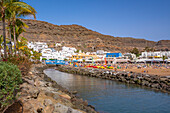 View of beach and colourful buildings along the promenade in the old town, Playa de Mogan, Gran Canaria, Canary Islands, Spain, Atlantic, Europe