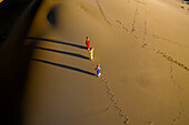 People walking home across Nam Cuong sand dunes, Ninh Thuan, Vietnam, Indochina, Southeast Asia, Asia