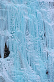 Ice climber on the Weeping Wall icefall in Banff National Park, Alberta, Canada.