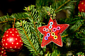 Switzerland, Basel. Basel Winter Holiday Market (aka Basler Weihnacht) at Barfusserplatz. Typical soft textile Christmas ornaments for sale at winter market.