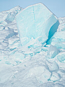 Iceberg frozen into the sea ice of the Melville Bay, near Kullorsuaq in the far north of West Greenland.