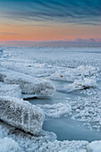 Vertical scenic sunset of Pancake and Frazil Ice and Pressure Ridges, Barrow, Alaska, Usa.