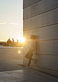 Tourist watching sunset on the roof of the Opera House in Oslo, Norway.