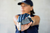 Golfer with Cap Holding Her Iron Golf Club with Her Golf Glove in a Sunny Day in Switzerland.