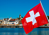 Swiss Flag in City of Lucerne with Lake in a Sunny Summer Day in Lucerne, Switzerland.