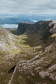 Scenic aerial view winding road through rugged mountain landscape, Bealach na Ba, Scotland