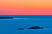 Canada, Ontario, Lake Superior Provincial Park. Islands in Lake Superior at sunset.