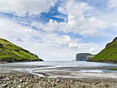 Beach at Tjornuvik. In the background the island Eysturoy with the iconic sea stacks Risin and Kellingin. Denmark, Faroe Islands