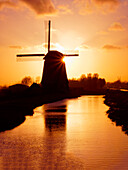 Netherlands, Nord Holland, Windmill along canal