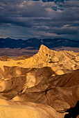 USA, California, Death Valley National Park. Clearing storm over sandstone formations at Zabriskie Point.