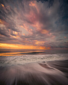 USA, New Jersey, Cape May National Seashore. Sunrise storm clouds over shoreline.