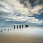 USA, New Jersey, Cape May National Seashore. Pier posts on beach.
