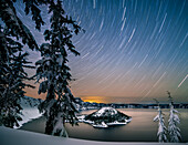 USA, Oregon, Crater Lake National Park. Star trails over Crater Lake and Wizard Island in winter.