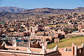 Africa, Morocco. The town of Boulmalne du Dades spills up the hillsides of the Atlas Mountain foothills.