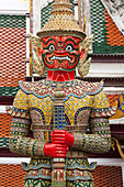 Thailand, Bangkok, Giant demon Suryapop guards the eastern entrance of Emerald Buddha Temple in the Royal Palace complex.