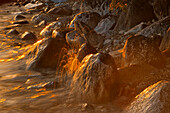 Canada, Manitoba, Clearwater Lake Provincial Park, Rocky shoreline of Clearwater Lake at sunset.