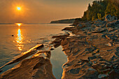 Canada, Ontario, Bruce Peninsula National Park. Sunset on limestone rock.