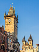 Europe, Czech Republic, Prague. Cityscape view on the clock tower and Tyn cathedral on the old square in Prague.