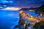 Italy, Vernazza. Overview of coastal town at sunset.