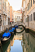 Gondola parking under Bridge. Venice. Italy.