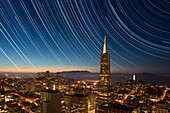 USA, California, San Francisco. Composite of star trails above Transamerica Building.