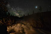 USA, Wyoming, Yellowstone National Park. Milky Way floats above a waterfall on the Firehole River in Yellowstone National Park.
