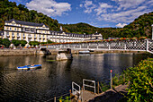 Couple in boat on the Lahn river in Bad Ems with a view of the spa bridge and spa building, Rhineland-Palatinate, Germany
