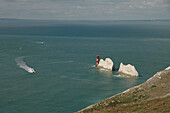 View of the Needles on the Isle of Wight at Freshwater with the lighthouse and small boats on the water