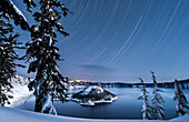 USA, Oregon, Crater Lake National Park. Star trails over Crater Lake and Wizard island in winter.