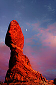 USA, Utah, Arches National Park. Moonrise over Balanced Rock sandstone formation.