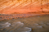 USA, Utah. Capitol Reef National Park, Fremont River and colorful, eroded sandstone wall.