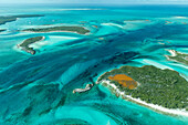 Aerial photo looking down at the clear tropical water and islands in the Exuma Chain of islands the Bahamas near Staniel Cay.