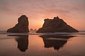 USA, Oregon, Bandon Beach. Sea stacks silhouetted at sunset