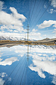 Powerlines in the landscape before the Grand Teton mountain range.