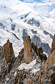 Blick von der Aiguille du Midi auf eine Felsnadel mit Bergsteigern, Vallée de Chamonix-Mont-Blanc, Le Mont-Blanc, Bonneville, Haute-Savoie, Auvergne-Rhône-Alpes, Frankreich