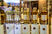 Showcase with several bottles of Italian grappa, Bassano del Grappa, Veneto, Italy