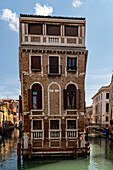 Ancient palace at the crossroads between two canals (rio san Giovanni and rio de la Teta), Venice, Veneto, Italy.