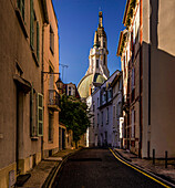 View through an alley in the old town of Vichy towards the Church of St. Blaise, Auvergne-Rhône-Alpes, France