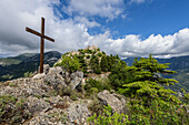 Cross and medieval castle above the hilltop village of Sainte-Agnès in the French Maritime Alps, Provence, France
